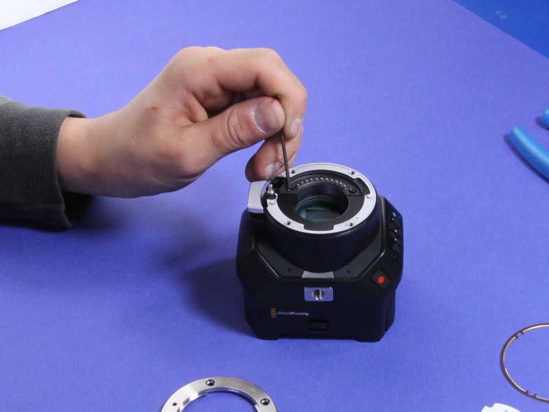 Hex key loosening an electrical contact block screw